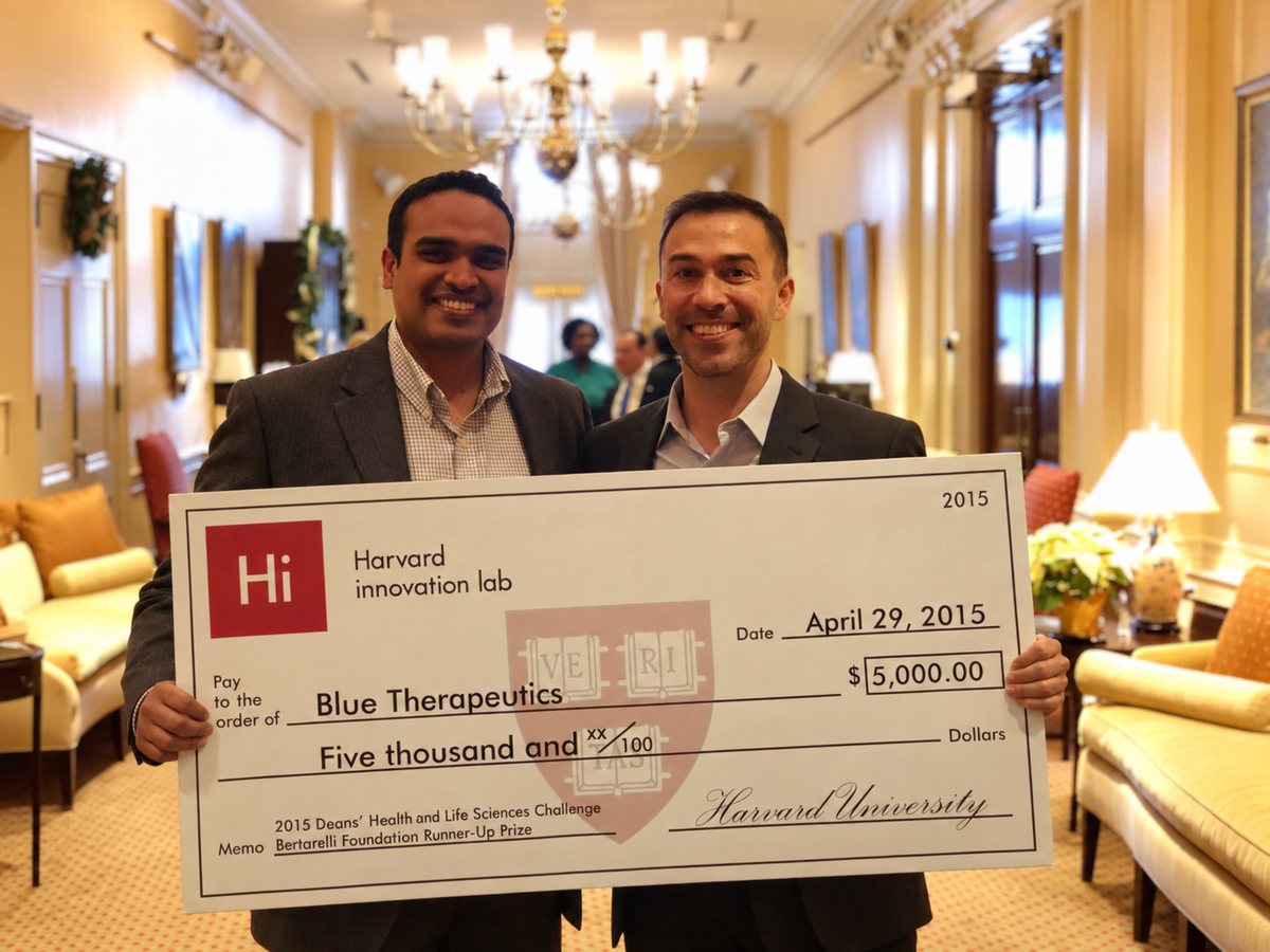 David Roberson and co-founder Ajay Yekkirala holding a Harvard Innovation Lab prize check made out to Blue Therapeutics