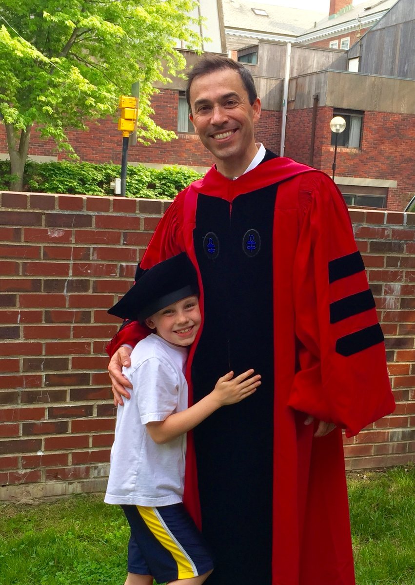 David Roberson in Harvard doctoral robes at commencement with his son