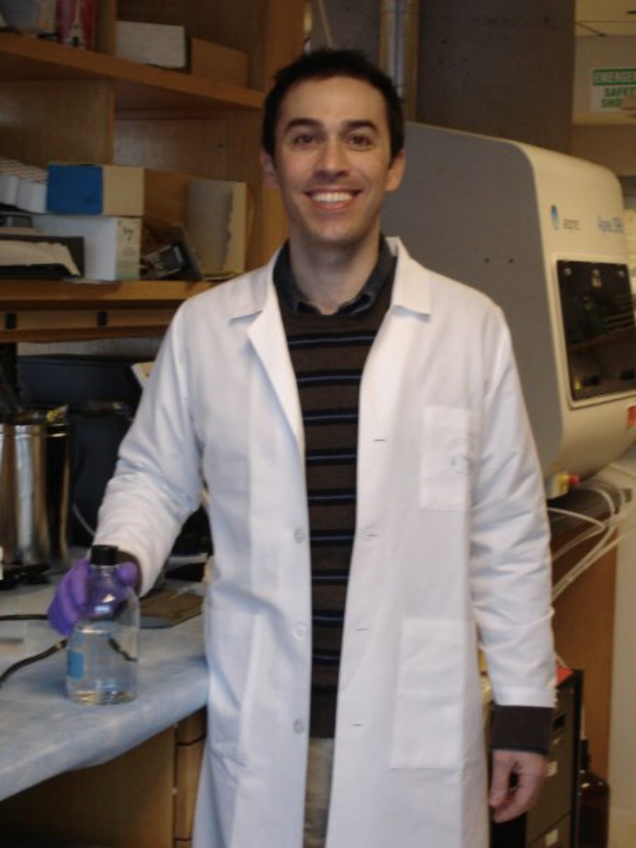 David Roberson in a lab coat in the lab at Harvard