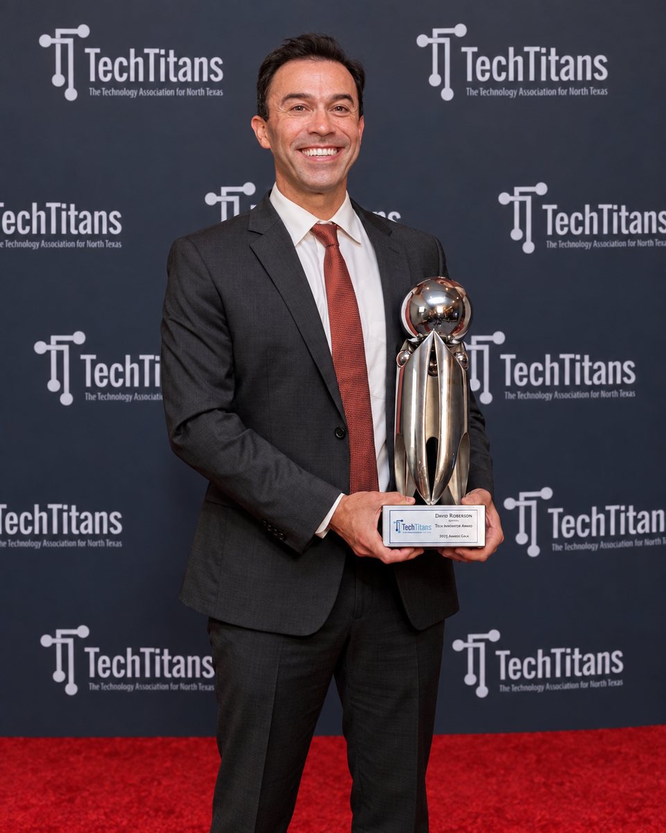 David Roberson holding the Tech Titans Technology Inventor Award trophy
